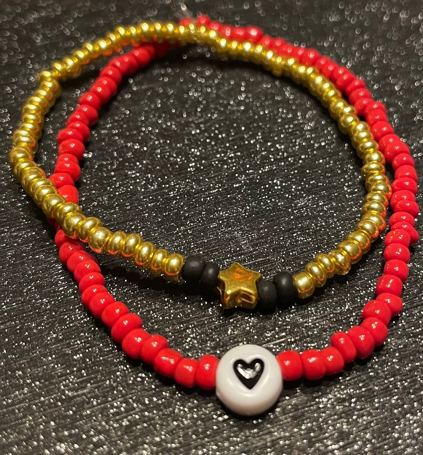 Gold star and red heart bracelets