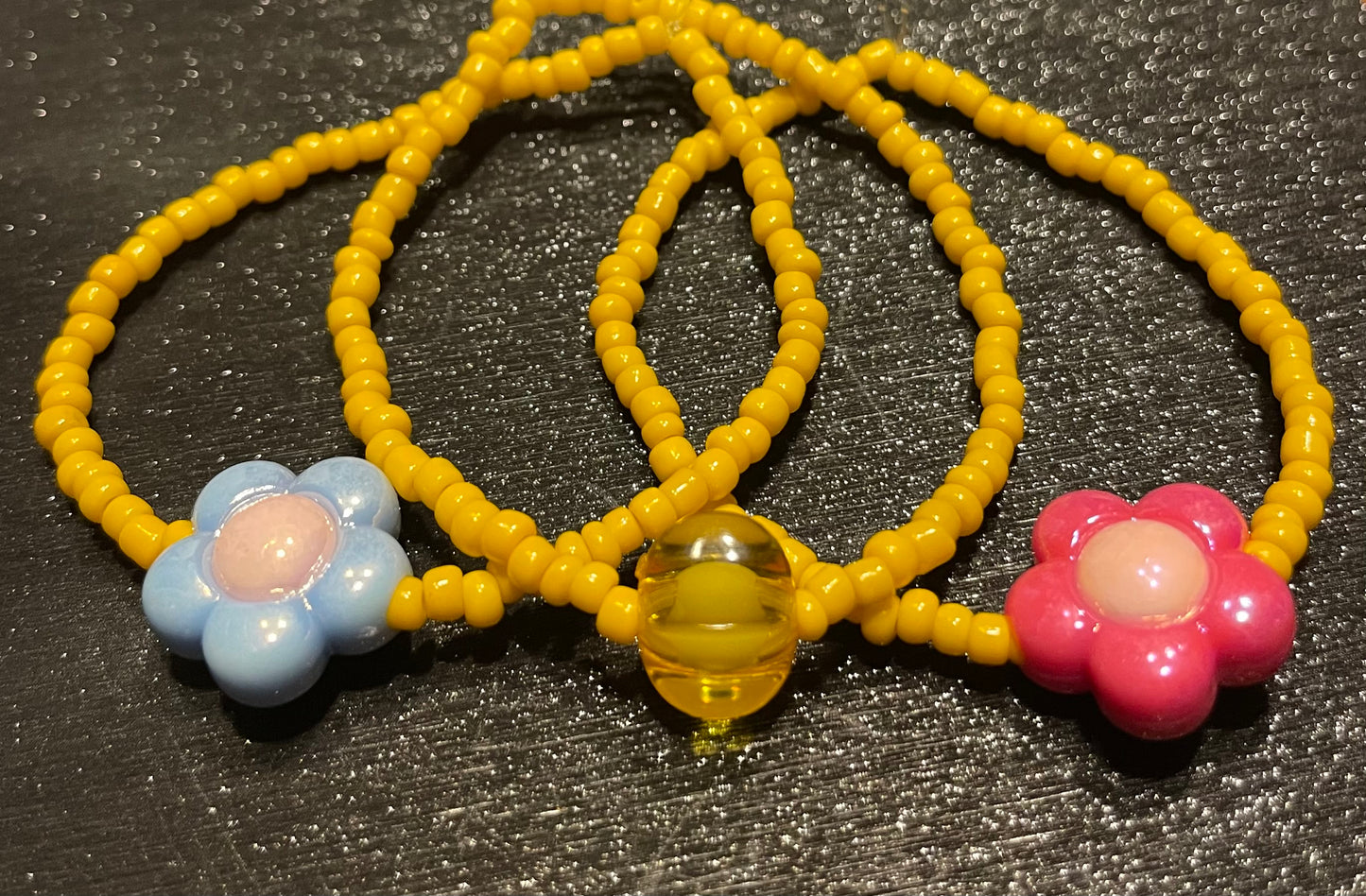 Yellow bracelets with flower charm