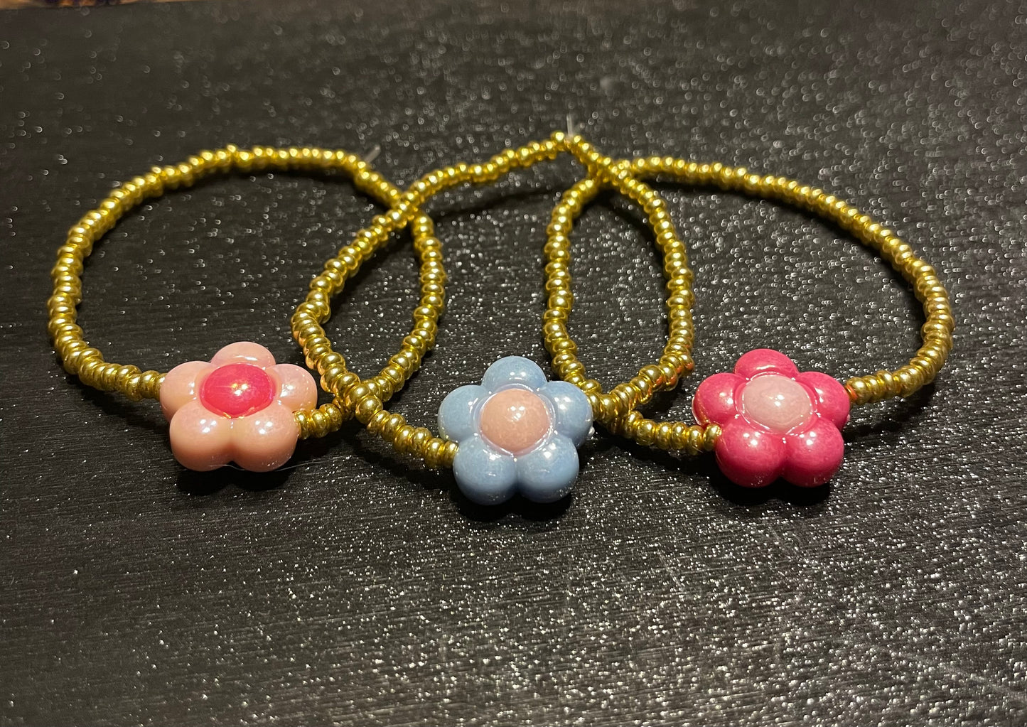 Gold beaded bracelets with flower